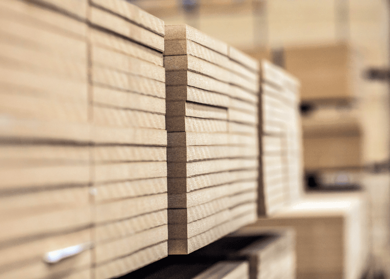 Detaljerad närbild av ett träskåp med lådor, med fokus på de horisontella snittytorna av träplankor. Texturen och ådringen i träet är tydligt synliga.